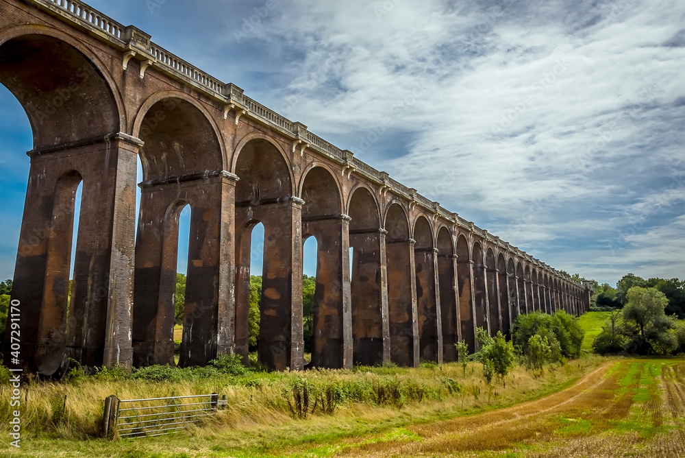 A view from a field down the length of  the Ouse Valley viaduct in Sussex, UK on a summers day