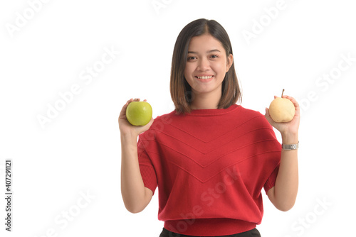 Portrait asian woman is holding an apple and a pear with both hands showing ecstasy on white background. Asian model. Cute woman.