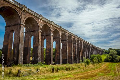 A view from a field down the length of  the Ouse Valley viaduct in Sussex, UK on a summers day photo