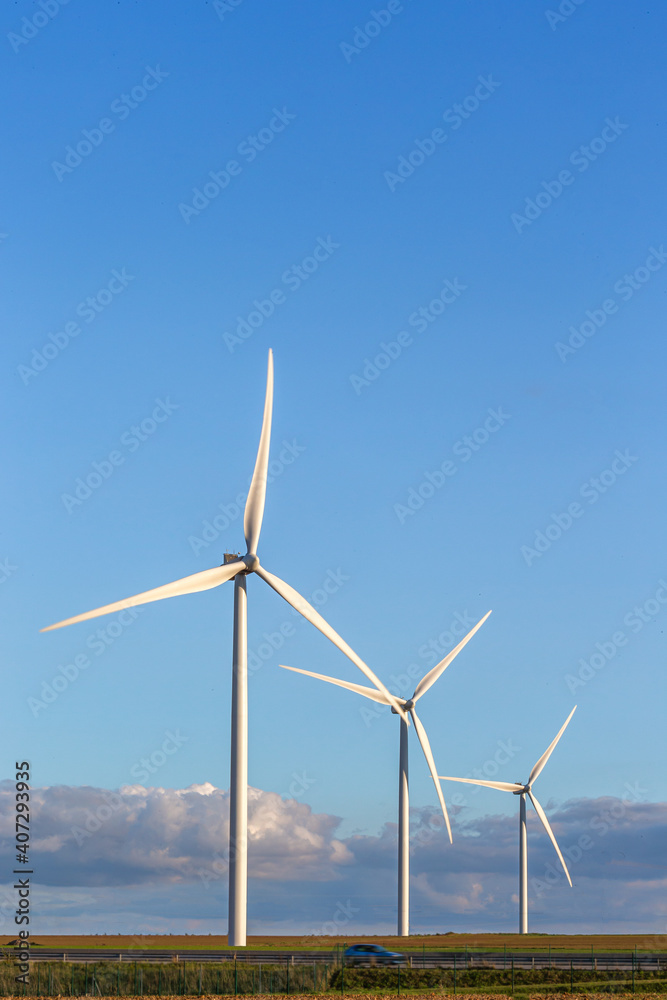 wind mill or also wind-turbine on wind farm in rotation to generate electricity energy