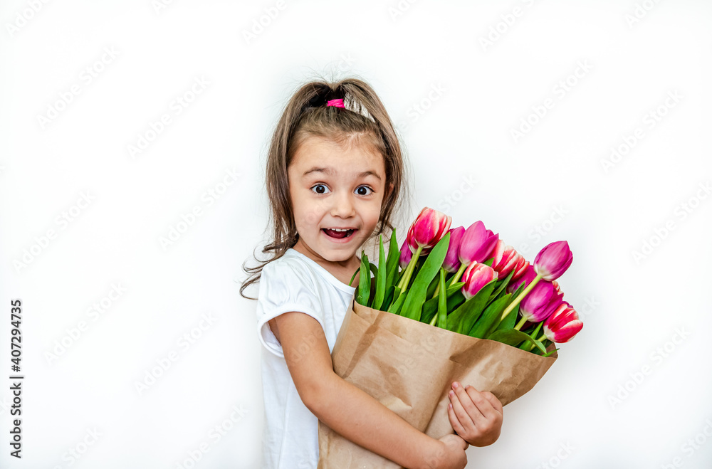 Portrait of a beautiful smiling little girl with spring tulips on a white background. International Women's Day. Girl 5 years old, Caucasian. Isolated.