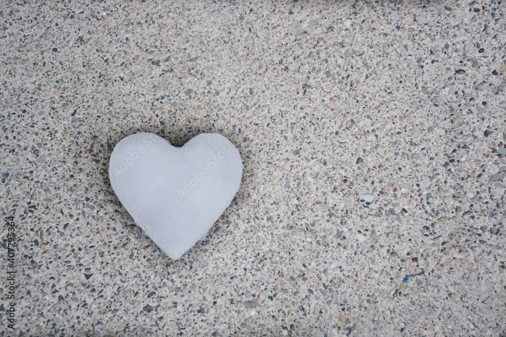 One heart made of snow on gray background, selective focus. Flat lay, Top view. One heart made of snow on gray background, selective focus. Flat lay, Top view.