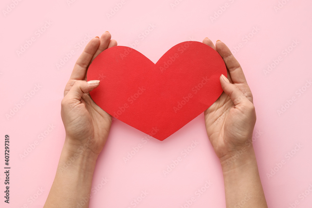 Hands with red heart on color background Hands with red heart on color background