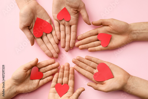 Hands with red hearts on co...