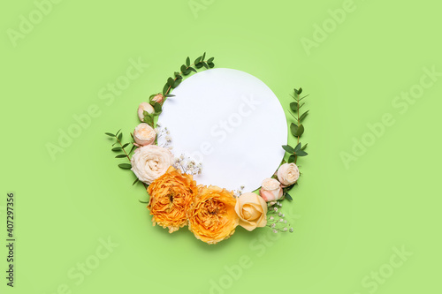 Empty card with fresh flowers on color background