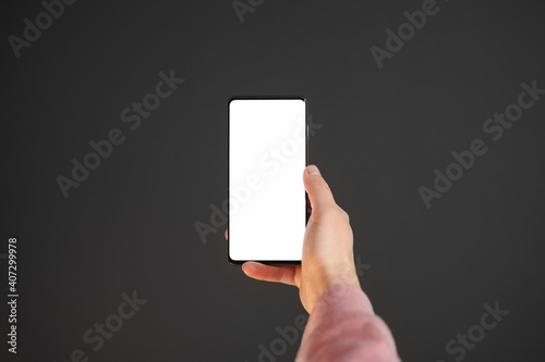 hand holds a phone with a white screen on a black background for copying