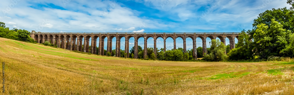 A view from the lower side of a field towards the Ouse Valley viaduct in Sussex, UK on a summers day