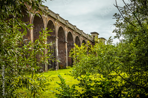 A view through the trees towards the southern end of the Ouse Valley viaduct in Sussex, UK on a summers day photo