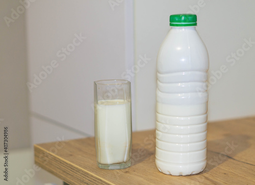 milk bottle and glass on wooden table