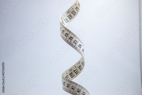 Close up of a two meter long measuring tape. Tape looks like a DNA strand.