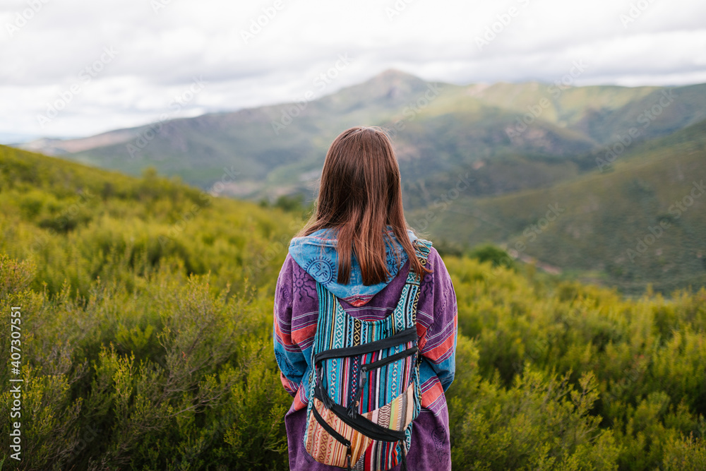 Woman with alternative clothes Looking at a big green mountain