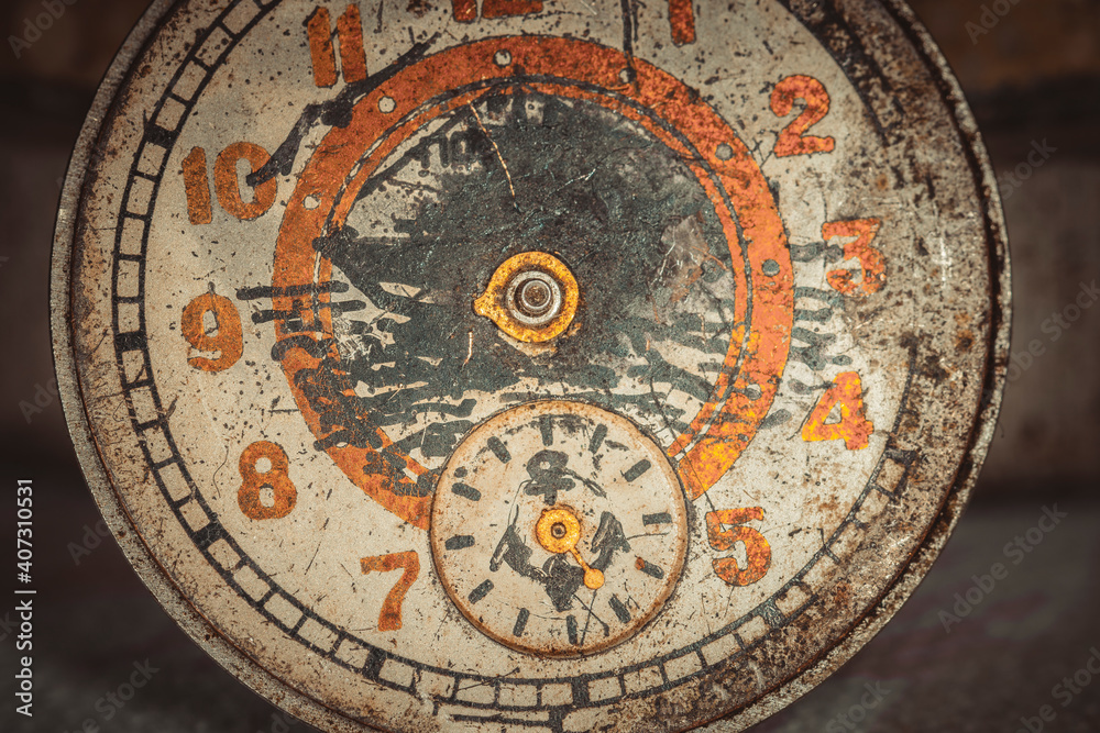 Obraz premium Vintage grunge background of an old clock. Abstract texture covered with dust, dirt, scratches. Macro photography in light tinted