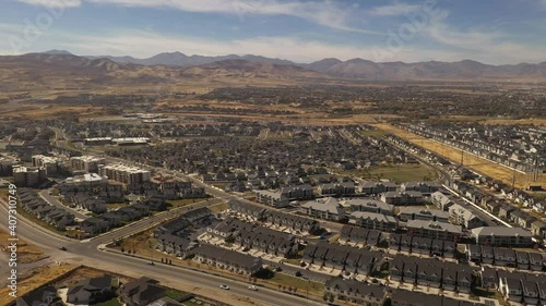 Aerial shot circling around suburban housing development with park photo