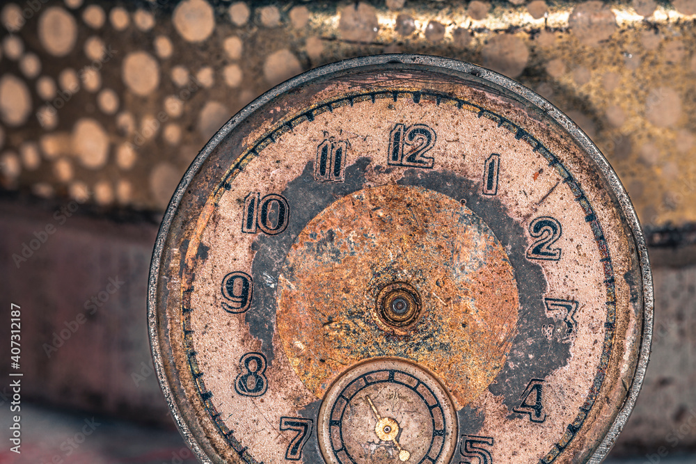 Vintage grunge background of an old clock. Abstract texture covered with dust, dirt, scratches. Macro photography in light tinted