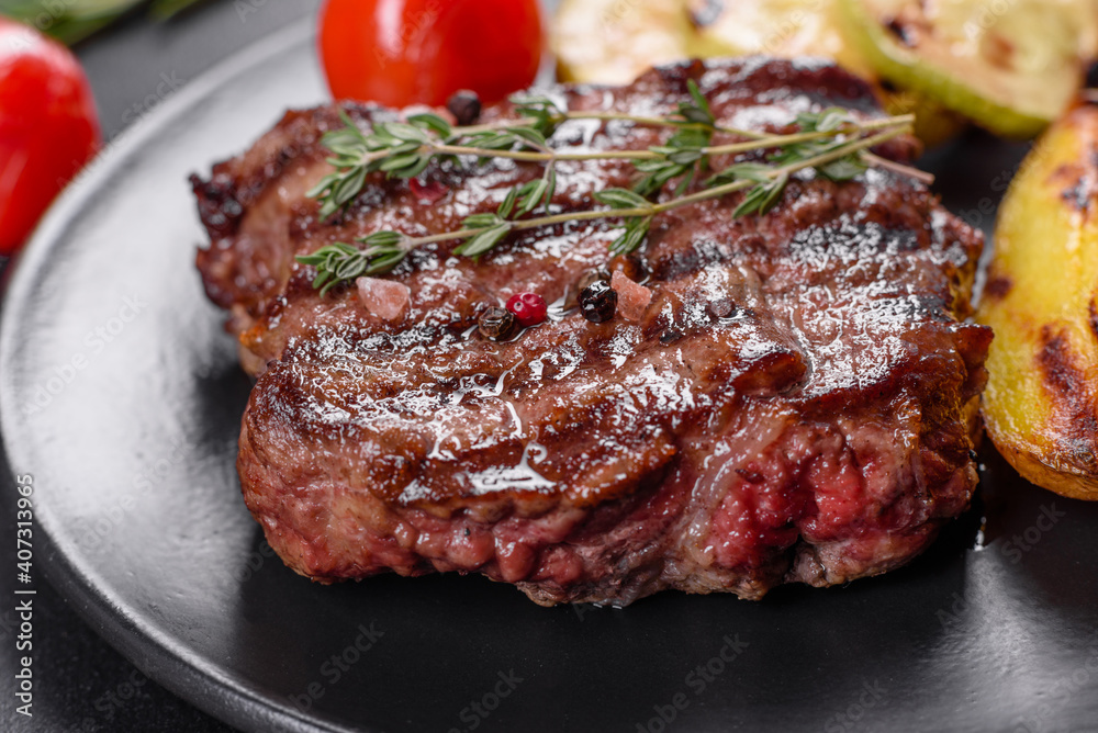 Fresh juicy delicious beef steak on a dark background