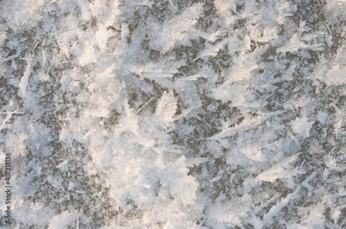 winter background. in the photo, white snowflakes on the ice in winter © fotofotofoto