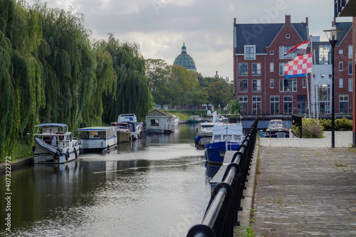 street in the town of Oudenbosch with harbor and waterway in background photo