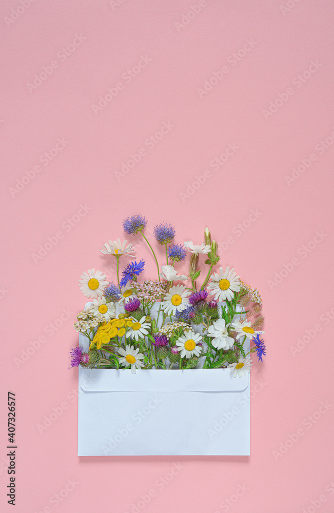 bouquet of flowers in white envelope and pink background.copy space.top view