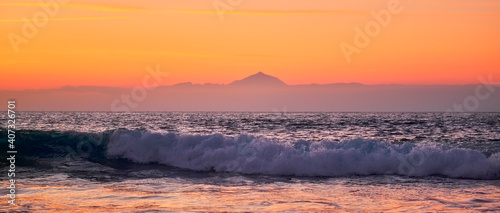 sunset over the Teide volcano and ocean wave photo