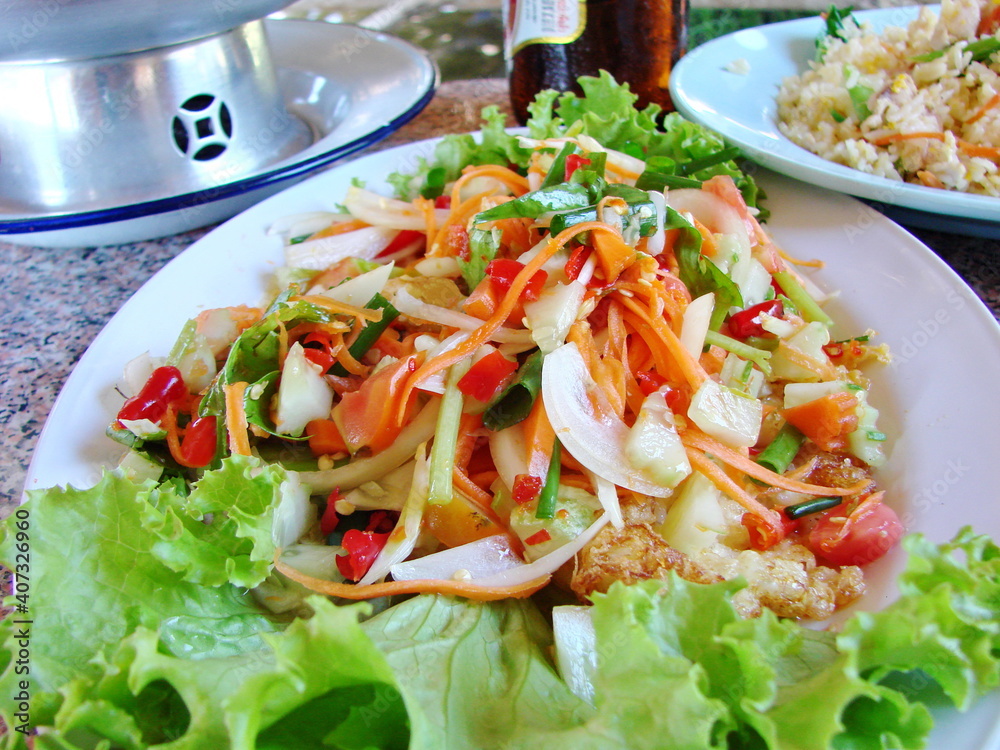 Thai spicy salad Somtam...The main ingredient is green papaya. Thai spicy salad Somtam...The main ingredient is green papaya.