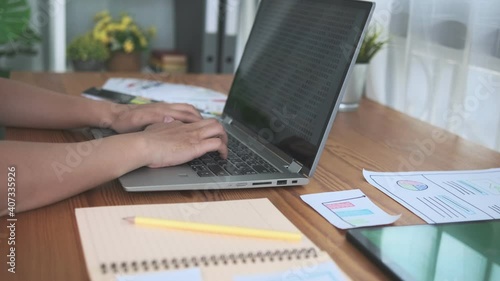 Working at home modern office Asian business woman typing on laptop computer close up typing camera slow motion panning, smiling happy successful business freelance small business entrepreneur.