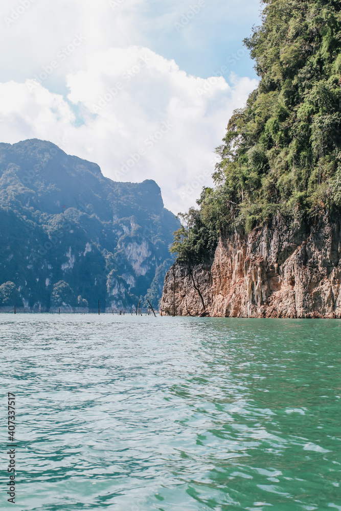Beautiful mountains lake river sky and natural attractions in Cheow Lan lake, Ratchaprapha Dam, Khao Sok National Park in Thailand in a summer day Beautiful mountains lake river sky and natural attractions in Cheow Lan lake, Ratchaprapha Dam, Khao Sok National Park in Thailand in a summer day