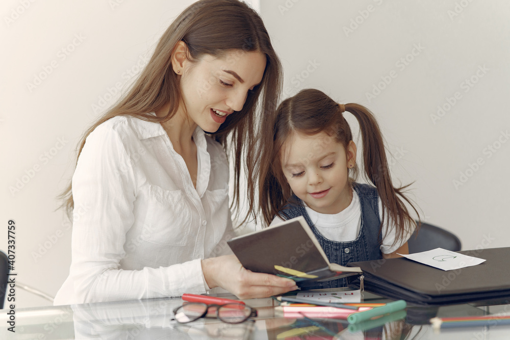 Tutor with pupil. Little girl studying. Private lesson. Tutor with pupil. Little girl studying. Private lesson.