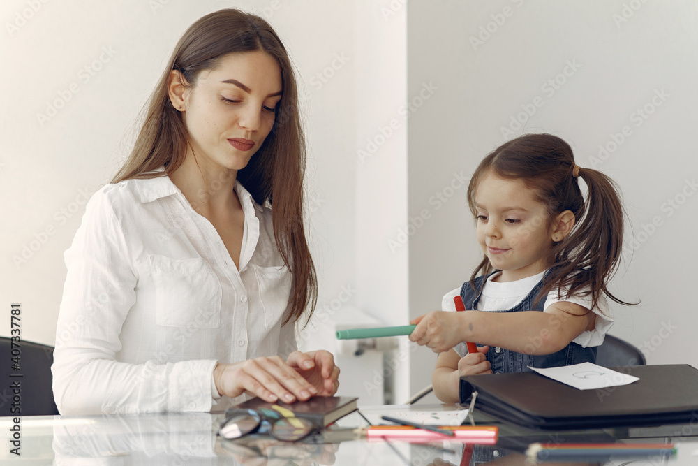 Tutor with pupil. Little girl studying. Private lesson. Tutor with pupil. Little girl studying. Private lesson.