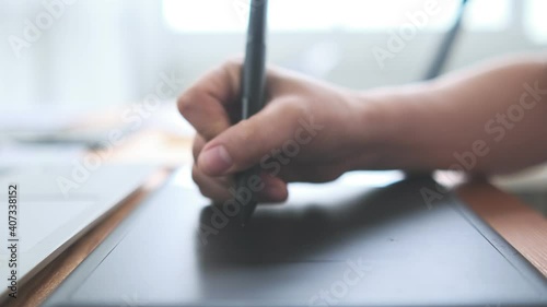 Creative designer Asian woman close up hand using stylus drawing sketching UI UX ideas project design on notebook and laptop, computer slow motion busy working at home modern office desk workspace.