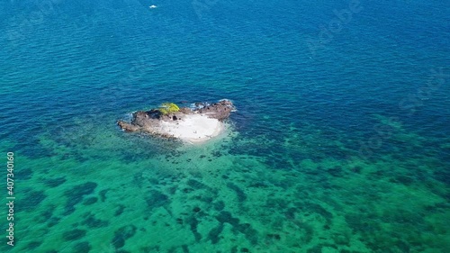 Islet In Middle Of Blue Sea With Calm Waves In Summer In Palawan Island, Philippines. - aerial photo