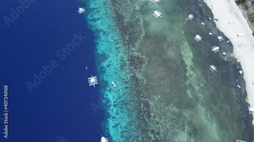 Bird's Eye View Of Blue Sea And Beach With Tourist Boats In Moalboal, Cebu, Philippines. - aerial photo