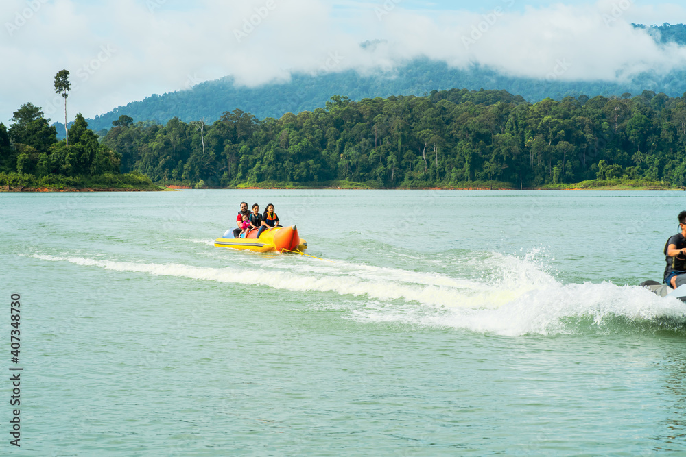 Fototapeta premium People enjoying water activities on banana boat at the Kenyir Lake, Terengganu, Malaysia.