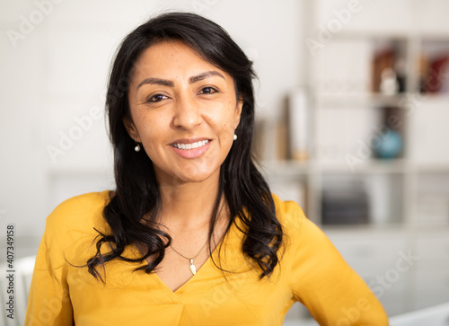 Vászonkép Portrait of smiling confident hispanic woman employee posing in light office int