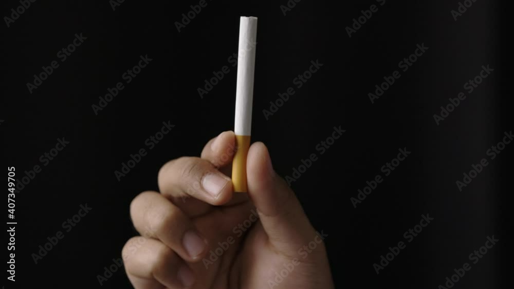 A young man with a cigarette He is going to smoke. Close up hand man showing a cigarette. World No Tobacco Day
A young man with a cigarette He is going to smoke. Close up hand man showing a cigarette. World No Tobacco Day