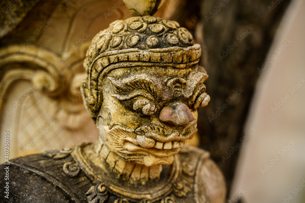 Old Buddha demon statue in close up
