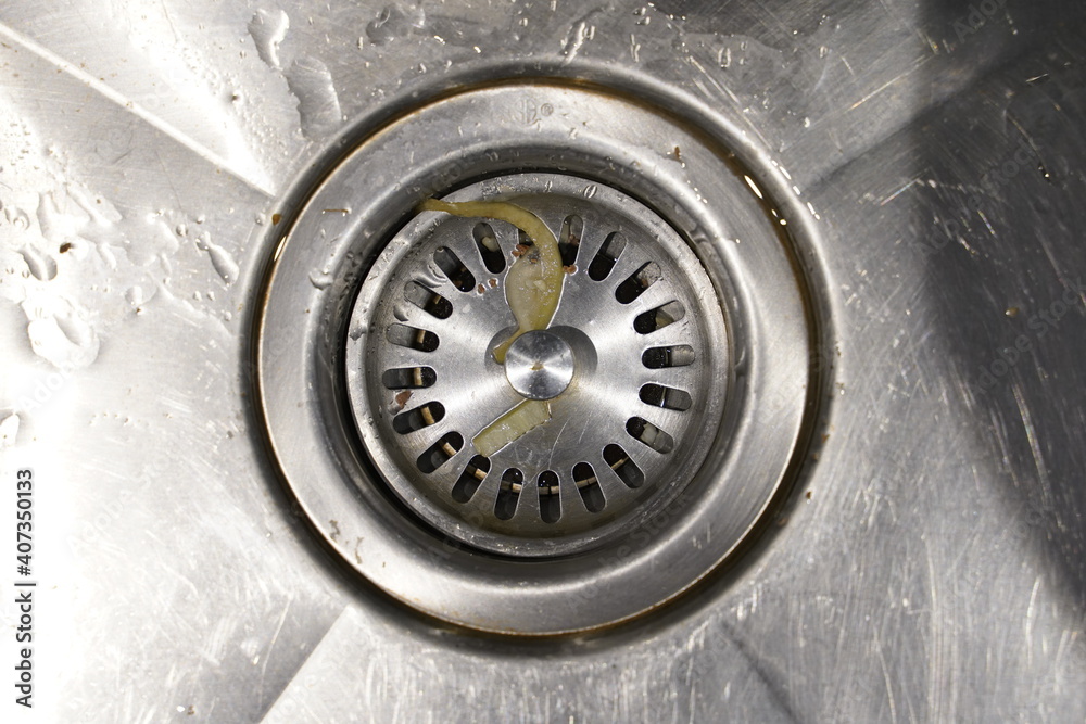 Water flowing into a kitchen drainage sink Water flowing into a kitchen drainage sink