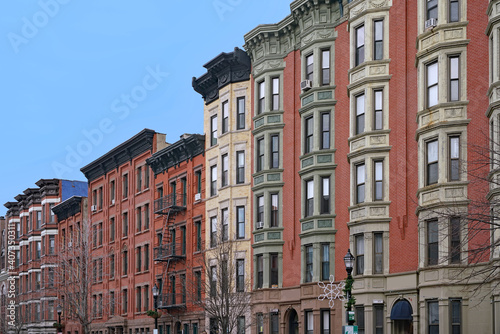 Street of well preserved old apartment buildings with ornate roof line cornice