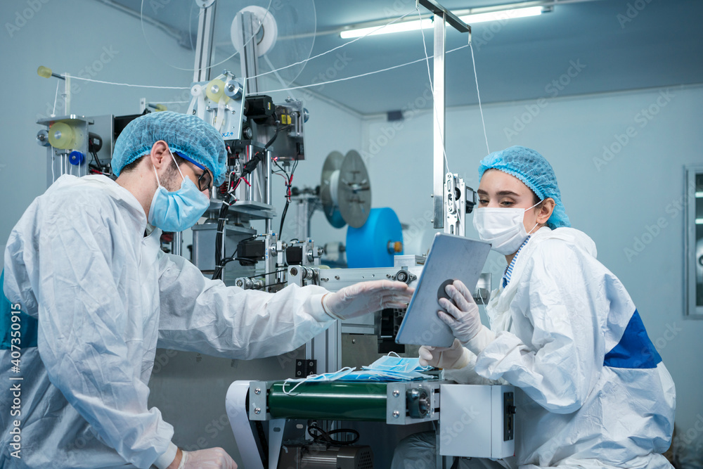 Staff and workers at the mask factory are monitoring the operation of the machines. A mask is being produced on the road. Factory workers are discussing. Staff and workers at the mask factory are monitoring the operation of the machines. A mask is being produced on the road. Factory workers are discussing.