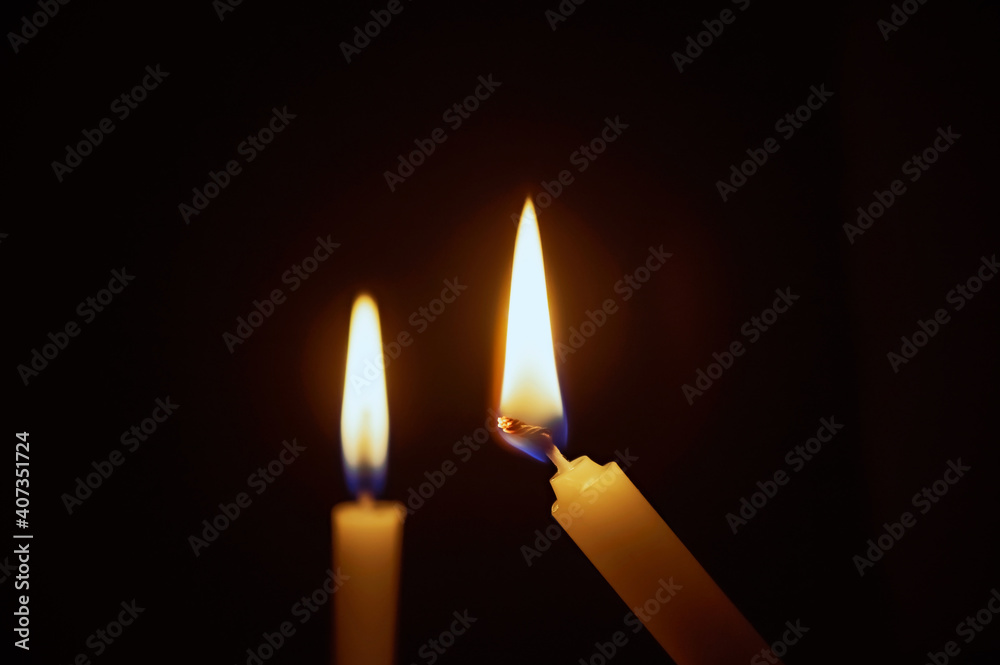 Candle lit in the dark. Candle flame at night. Lighting design for background. lighting candles, Burning candle on black background. Candle in the dark. Candle lit in the dark. Candle flame at night. Lighting design for background. lighting candles, Burning candle on black background. Candle in the dark.