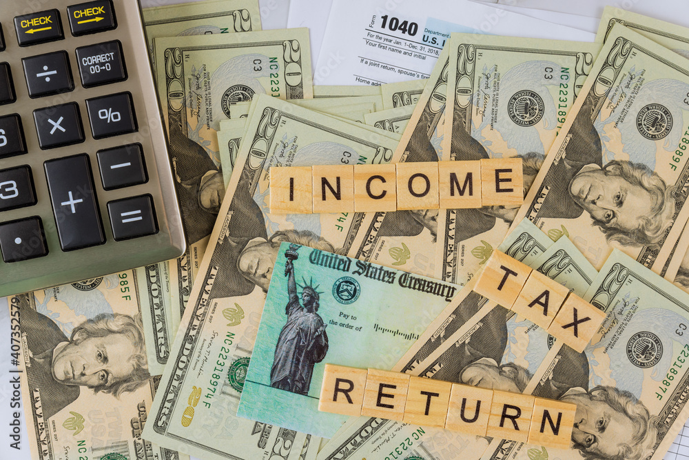 Individual Income Tax return form 1040 U.S. with calculator on US american dollars