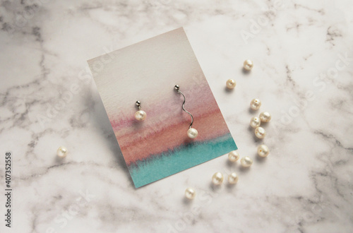 pearl earrings on marble background