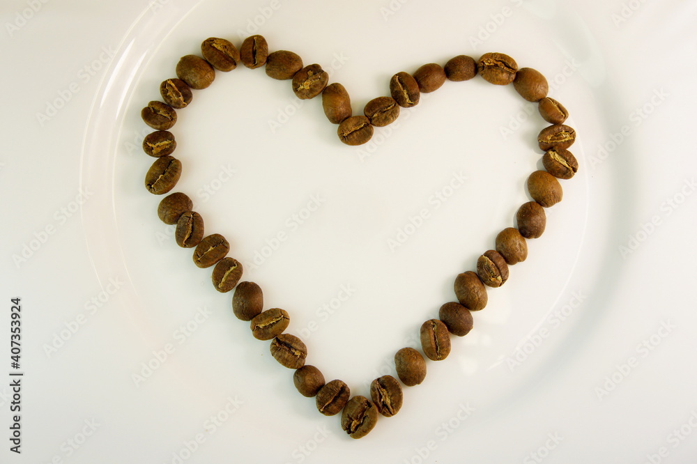 heart lined with coffee beans. coffee heart on a white background. I like coffe. background for Valentines Day - heart made of coffee beans heart lined with coffee beans. coffee heart on a white background. I like coffe. background for Valentines Day - heart made of coffee beans