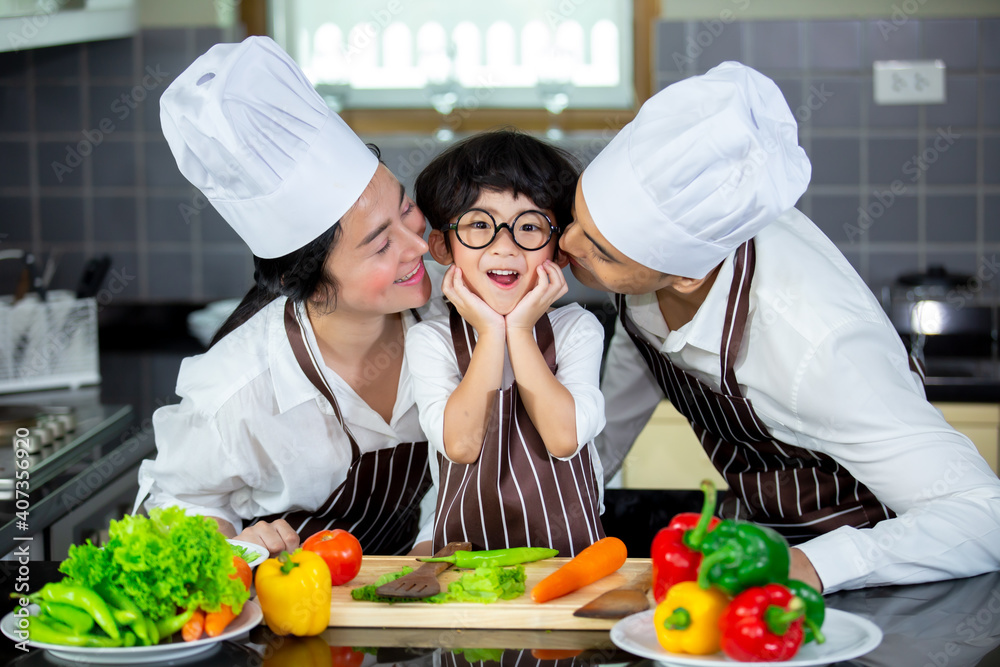 Happy smiling young Asian family with preschool kids have fun cooking breakfast meal in modern kitchen home in the morning. Happy smiling young Asian family with preschool kids have fun cooking breakfast meal in modern kitchen home in the morning.