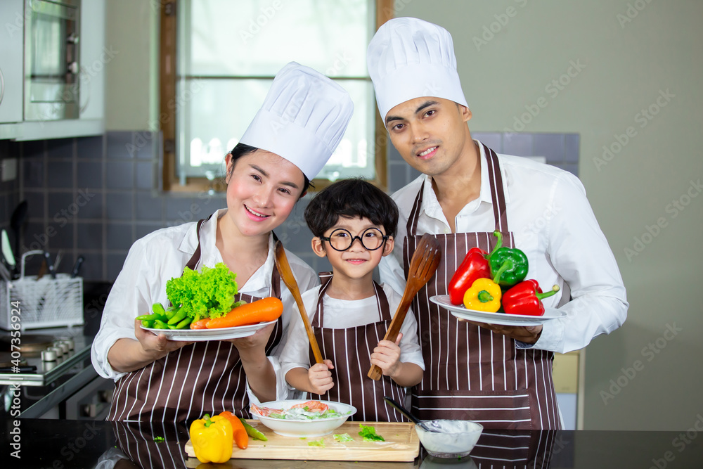 Happy smiling young Asian family with preschool kids have fun cooking breakfast meal in modern kitchen home in the morning. Happy smiling young Asian family with preschool kids have fun cooking breakfast meal in modern kitchen home in the morning.