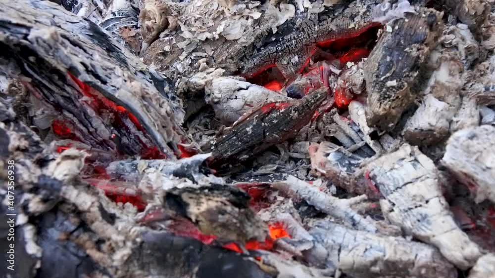 Smouldering embers of a campfire close-up . Smouldering embers of a campfire close-up .