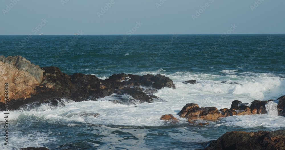 Sea wave hit the coastal cliffs