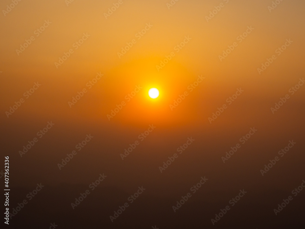 Beautiful sunset view with sparkles in the middle of the image. In the evening there were yellow and orange lights in the clear sky.