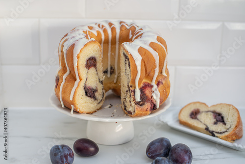 typical German poppy seed plum gugelhupf cake on a table photo