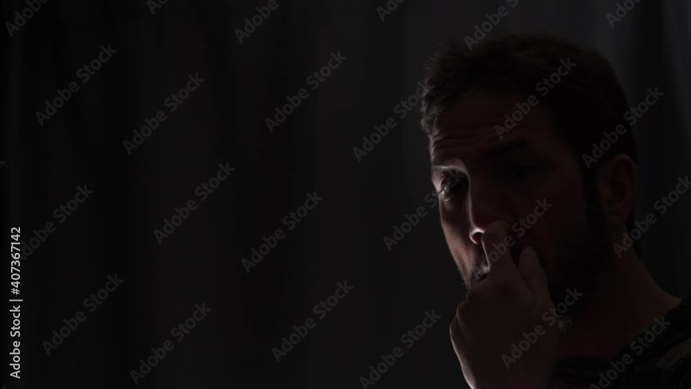 A man picking his nose to get rid of excess mucus caused by illness A man picking his nose to get rid of excess mucus caused by illness