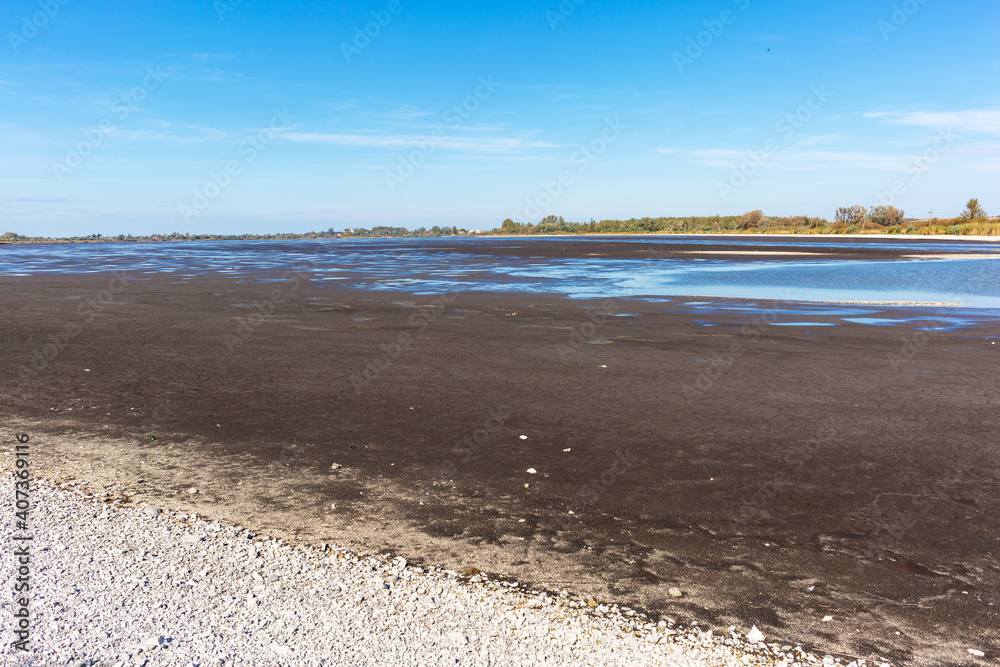 The bottom surface of the lake after the descent of water. Сleaning the bottom of the lake.